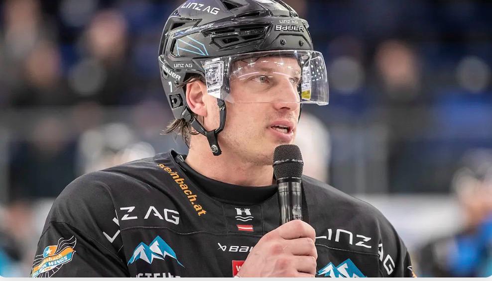Brian Lebler speaking on the ice after a game in Linz